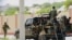 FILE - Somali soldiers are seen riding on a pick-up truck in Mogadishu, Somalia, April 27, 2022. 