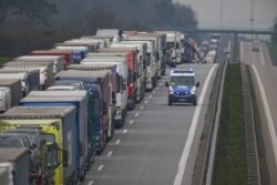 A police vehicle is seen passing a truck back-up near the German-Polish border, near Frankfurt an der Oder, during the coronavirus outbreak in Germany, March 19, 2020.