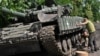 Ukrainian servicemen repair a tank on a road in Donetsk region on June 30, 2023, amid the Russian invasion of Ukraine. 