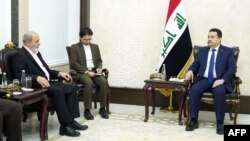 A handout picture released by Iraq's Prime Minister's Media Office on Feb. 5, 2024, shows Iraq's Prime Minister Mohamed Shia al-Sudani, right, meeting with Ali Akbar Ahmadian, left, secretary of Iran's Supreme National Security Council, in Baghdad. 