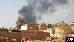 This picture taken in Aljazeera Eslang, north of Khartoum, shows smoke billowing in Omdurman, the capital's twin city, Sudan, July 3, 2023. 
