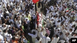 FILE - Thousands take part in a mass funeral procession for 27 people killed in a suicide bombing, at the Grand Mosque in Kuwait City, Kuwait, on June 27, 2015.