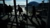 FILE - Passengers make their way through the terminal at Washington Dulles International Airport in Dulles, Virginia, Nov. 22, 2023.