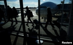 Passengers make their way through the terminal as they travel ahead of the Thanksgiving holiday at Washington Dulles International Airport in Dulles, Virginia, Nov. 22, 2023.