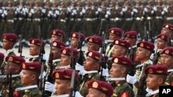 FILE - Military officers march during a parade in Naypyitaw, Myanmar, March 27, 2023. The country's military government revealed last week how it will implement its newly activated conscription law.