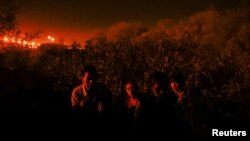 Migrants from Guatemala cross the Rio Bravo with the intention of turning themselves in to U.S. Border Patrol agents to request asylum, in El Paso, Texas, Sept. 22, 2023.