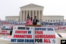 A person protests outside of the Supreme Court in Washington, June 29, 2023.