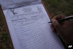 A game counter jots down notes on animals spotted during a game count in Gonarezhou National Park, Oct. 29, 2023.