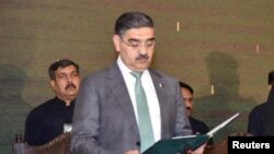 FILE - Pakistan's caretaker Prime Minister Anwaar-ul-Haq Kakar takes the oath of office, in Islamabad, Pakistan, Aug. 14, 2023. (Press Information Department/Handout via Reuters)