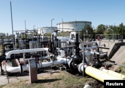 FILE - The Druzhba oil pipeline between Hungary and Russia is seen at the Hungarian MOL Group's Danube Refinery in Szazhalombatta, Hungary, May 18, 2022.