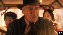This image released by Lucasfilm shows Ethann Isidore, from left, Harrison Ford and Phoebe Waller-Bridge in a scene from "Indiana Jones and the Dial of Destiny."