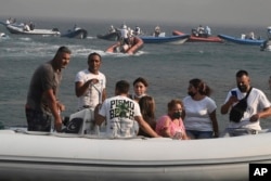 Boats arrive to help evacuate residents and tourists from the town of Nea Anchialos, near Volos city, central Greece, July 27, 2023.