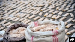 FILE - In this photo released by the Syrian official news agency SANA, Syrian authorities display Captagon pills, in rural Damascus, Syria, Nov. 30, 2021. 