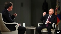 FILE - In this photo released by Sputnik news agency, Feb. 9, 2024, U.S. commentator Tucker Carlson interviews Russian President Vladimir Putin in Moscow on Feb. 6, 2024. Part of the interview was used to create a history quiz that Russian school children took this month.