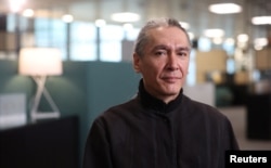 FILE - Kim Aris, the son of Aung San Suu Kyi, Myanmar's detained former leader, poses for a portrait at the Reuters office in London, April 18, 2024.