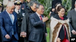 Chinese Premier Li Qiang, center, stands with New Zealand Prime Minister Christopher Luxon, left, and New Zealand Governor General Dame Cyndi Kiro during the official welcome ceremony in Wellington, New Zealand, June 13, 2024.