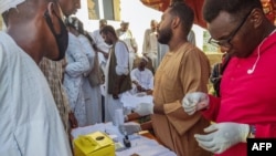 People queue at a medical laboratory to get tested for dengue fever in the eastern Gedaref state of Sudan, Sept. 22, 2023.