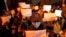 FILE - Protesters hold up blank papers and chant slogans as they march in protest in Beijing, Nov. 27, 2022.