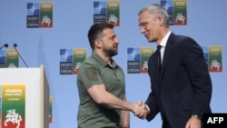 NATO Secretary-General Jens Stoltenberg shakes hands with Ukrainian President Volodymyr Zelenskyy after a joint press conference on the sidelines of the NATO Summit in Vilnius, July 12, 2023.