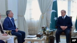 Photo by Press Information Department, Swiss Foreign Minister Ignazio Cassis, left, meets with Pakistan's Prime Minister Shehbaz Sharif at Nathia Gali resort, Pakistan, June 8, 2023.