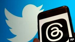 This photo, taken in New York on July 5, 2023, show the logo for Meta's new app Threads, right, and that of Twitter. 