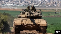 An Israeli army battle tank moves at a position along the border between southern Israeli and the Gaza Strip on Jan. 31, 2024. 