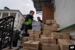 People take free spiritual books at a library of the Monastery of the Caves in Kyiv, March 23, 2023.