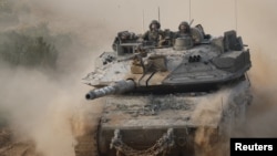 An Israeli tank return from the southern Gaza strip, in southern Israel, Feb. 26, 2024.