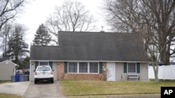 A vehicle is parked in the driveway of a home that was a scene of a murder in Levittown, Pa., on Jan. 31, 2024.