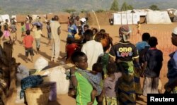 FILE - Refugees wait for registration at Kapise camp in Malawi's Mwanza district, Jan. 18, 2016.