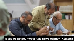Electoral staff count ballots in Tehran, Iran, after voting ended in a snap presidential election to choose a successor to Ebrahim Raisi following his death in a helicopter crash, June 29, 2024. (Majid Asgaripour/West Asia News Agency via Reuters)