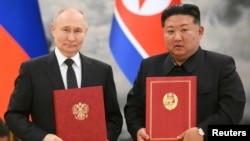 Russia's President Vladimir Putin and North Korea's leader Kim Jong Un pose for a photo during a signing ceremony following bilateral talks in Pyongyang, North Korea, June 19, 2024. (Sputnik/Kristina Kormilitsyna/Kremlin via Reuters)