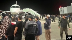 People shout antisemitic slogans at an airfield of the airport in Makhachkala, Russia, Oct. 30, 2023, after a flight arrived from Israel.