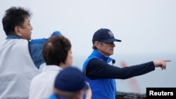 Rafael Mariano Grossi listens to Tomoaki Kobayakawa, President of Tokyo Electric Power Co., while visiting the damaged Fukushima nuclear power plant in Futaba, Japan, July 5, 2023. (Hiro Komae/Pool via Reuters)