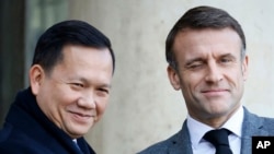 FILE — French President Emmanuel Macron, right, winks as he welcomes Cambodia's Prime Minister Hun Manet in Paris, Jan. 18, 2024. Hun Manet has enjoyed warming relations with the West during his first few months in power despite maintaining much of his father's hardline tactics.