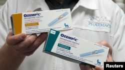 FILE - A pharmacist displays boxes of Ozempic, a drug used for treating type 2 diabetes and obesity made by Novo Nordisk, at Rock Canyon Pharmacy in Provo, Utah, March 29, 2023. 