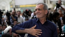 Iran's President-elect Masoud Pezeshkian greets supporters at the shrine of the architect of the Iranian Revolution and the Islamic Republic's first supreme leader, Ayatollah Khomeini, outside of Tehran, Iran, July 6, 2024.