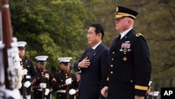 Japan's Prime Minister Fumio Kishida, with Commanding General Military District of Washington Maj. Gen. Trevor Bredenkamp, right, attends a wreath-laying ceremony at the Tomb of the Unknown Soldier, in Arlington, Virginia, April 9, 2024.
