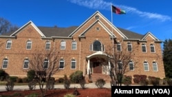 The flag of the former Afghan Republic is hoisted outside an office of the Afghanistan United Front in the U.S. state of Virginia.