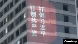 资料照：中国山东济南万达广场的高楼外墙上出现遥控打出的打倒共产党、打倒习近平的标语。(2023年2月21日)