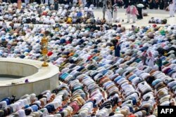 Muslim pilgrims pray around the Kaaba, Islam's holiest shrine, at the Grand Mosque in the holy city of Mecca at the end of the annual hajj pilgrimage, June 18, 2024.