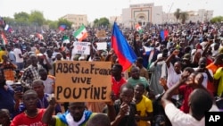 Nigeriens participate in a march called by supporters of coup leader Gen. Abdourahmane Tchiani in Niamey, Niger, July 30, 2023. 