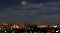 FILE - In this photo released by the Syrian official news agency SANA, shows missiles flying in the sky near Damascus International Airport, in Damascus, Syria, Jan. 21, 2019.