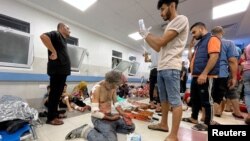 Palestinians who were wounded after a convoy of ambulances was hit, are assisted at Shifa hospital in Gaza City, Nov. 3, 2023.
