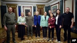 In this photo provided by the Ukrainian Presidential Press Office, Ukrainian President Volodymyr Zelenskyy, third from left, poses with eco-activist Greta Thunberg, third right, and European and Ukrainian officials in Kyiv, Ukraine, June 29, 2023.