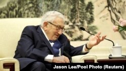 FILE - Former U.S. Secretary of State Henry Kissinger speaks during a meeting at the Great Hall of the People in Beijing, China, Nov. 22, 2019. The 100-year-old veteran U.S. diplomat also met with a Chinese official on Tuesday. (Jason Lee/Reuters/Pool Photo) 