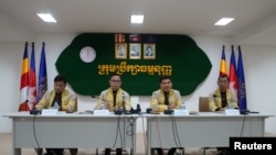 FILE - Members of the Constitutional Council of Cambodia announces the election disqualification of the Candlelight Party for the upcoming election in Phnom Penh, Cambodia, May 25, 2023.