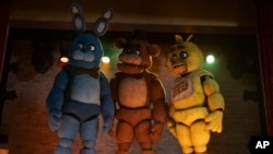 This image released by Universal Pictures shows, from left, Bonnie, Freddy Fazbear and Chica in a scene from "Five Nights at Freddy's." (Universal Pictures via AP)