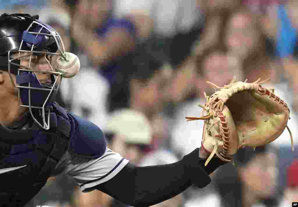 Cleveland Guardians catcher Bo Naylor keeps his eye on the ball as it is fouled off by Chicago Cubs' Seiya Suzuki during the fourth inning of a baseball game, July 1, 2023, in Chicago.
