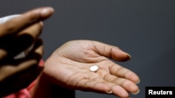 A patient prepares to take Mifepristone at Alamo Women's Clinic in Carbondale, Illinois, April 20, 2023.